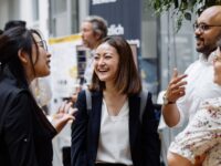 business school international students laughing at career fair