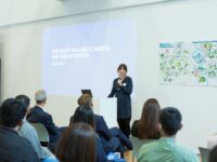 woman talking in front of a group of people