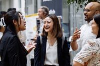 business school international students laughing at career fair