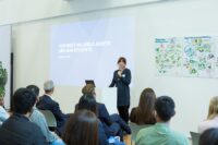 woman talking in front of a group of people