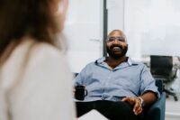 man sitting in an armchair smiling