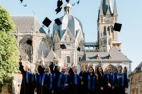 group of graduates throwing their hats