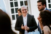 man in suit smiling into the camera