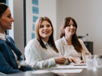 3 women sitting at a conference table