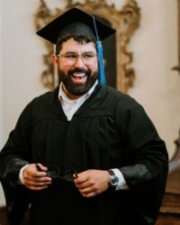 graduate in robe and hat happy