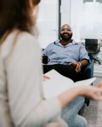 man sitting on a couch and smiling