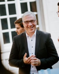 man in suit smiling into the camera