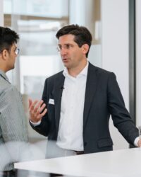 two men in a conversation at a formal event